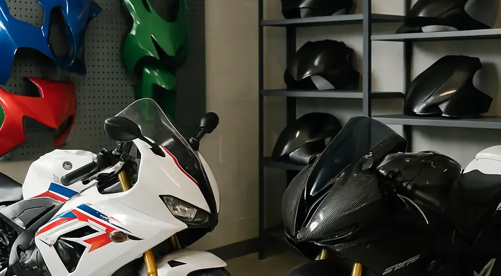 Assorted motorcycle fairings ranging from affordable to premium displayed in a retail and workshop setting.