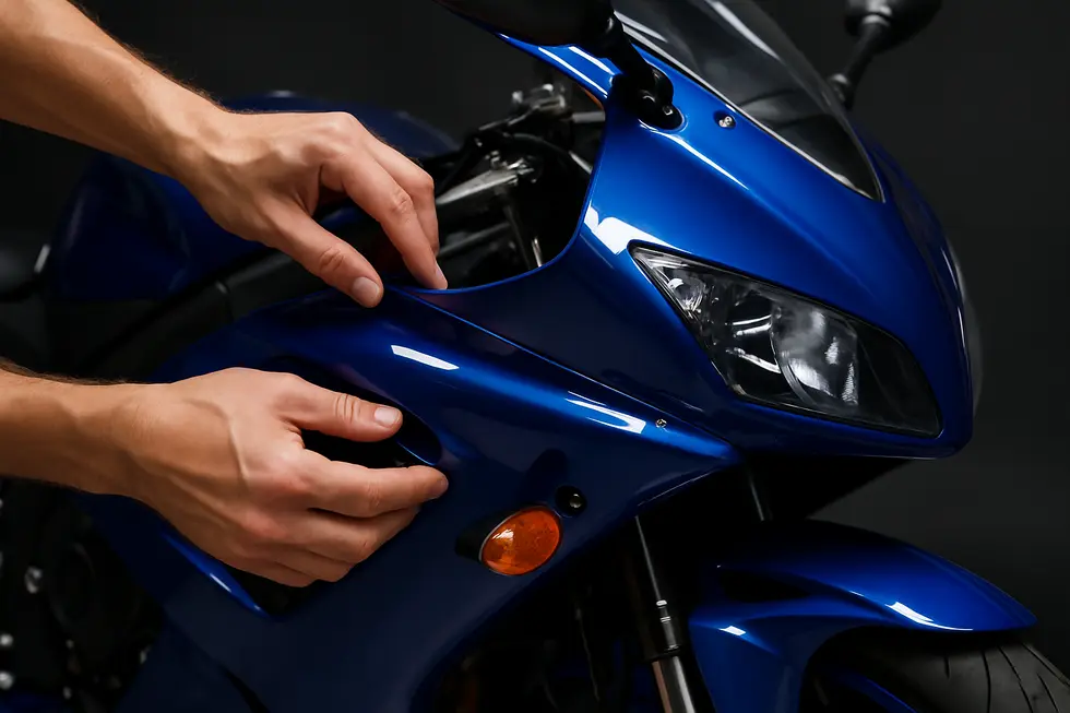 Technician delicately removing motorcycle fairings to prepare for precise damage assessment and repair.