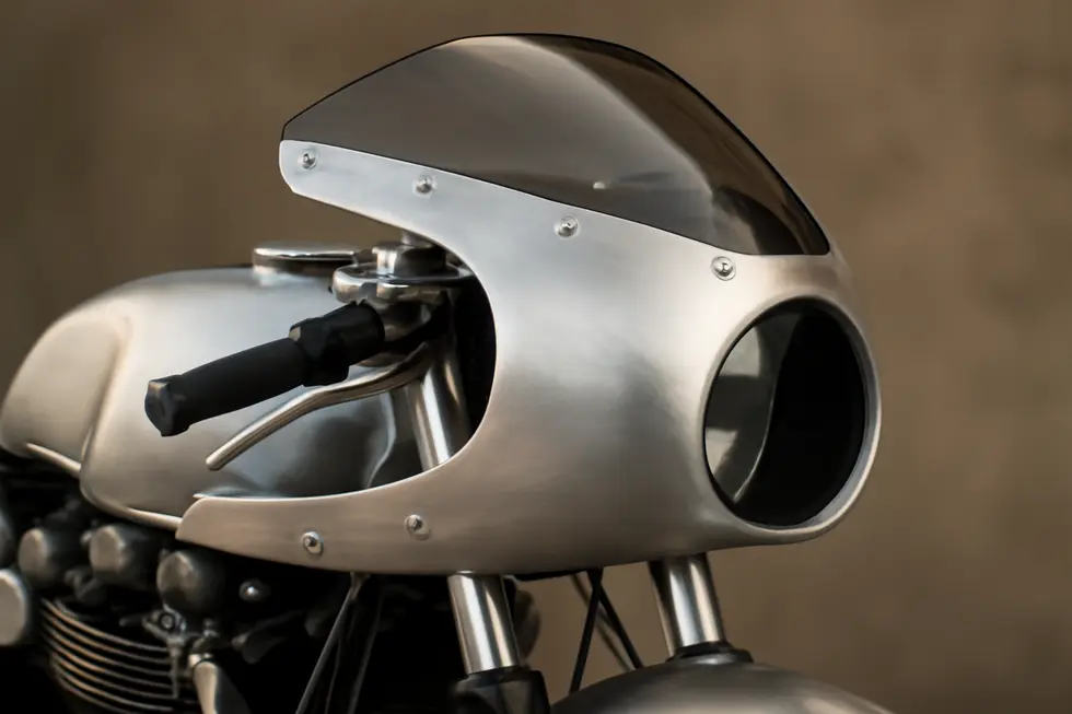 Artisan crafting a premium aluminium motorcycle fairing illustrating precision design and robust construction.
