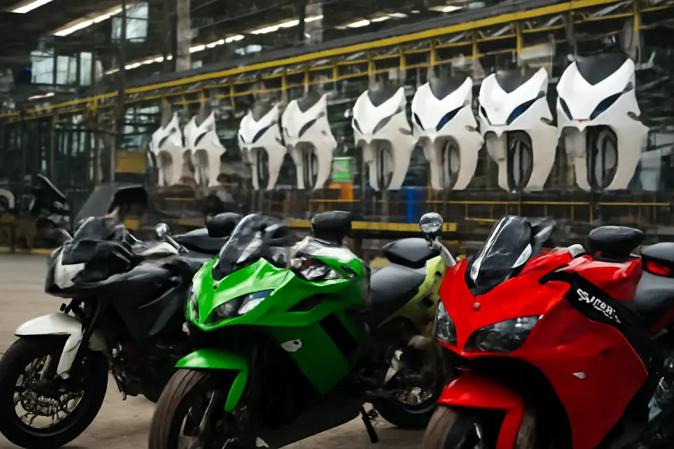 An artisan preparing a master motorcycle fairing model essential for mold making.
