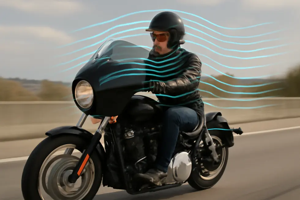 A glossy black bullet fairing showcasing its aerodynamic design fitted on a cruiser motorcycle.