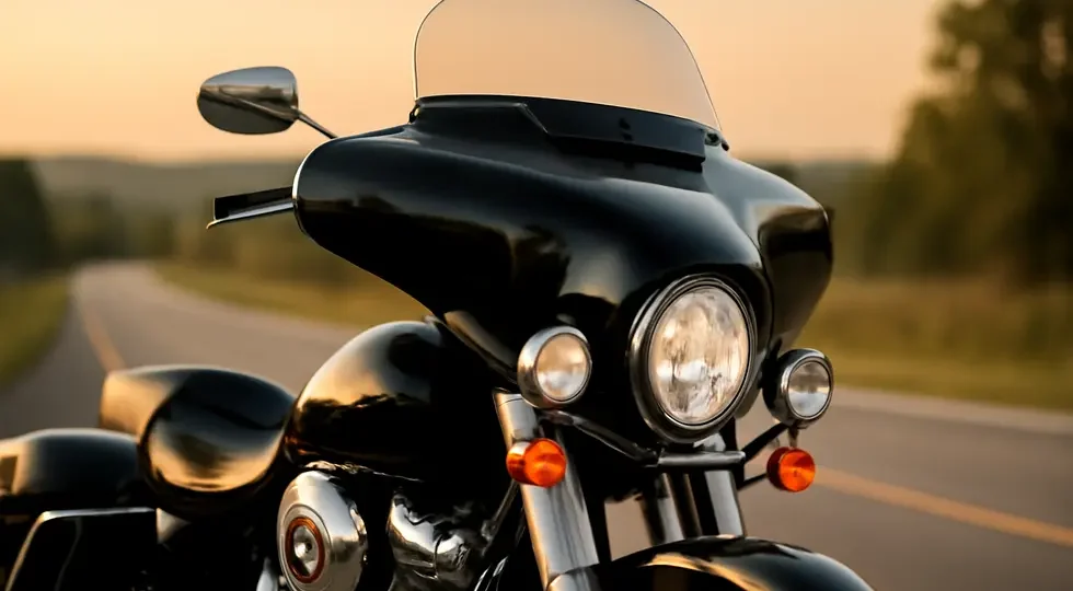 Classic cruiser motorcycle showcasing a sleek batwing fairing under golden hour light on an open road.