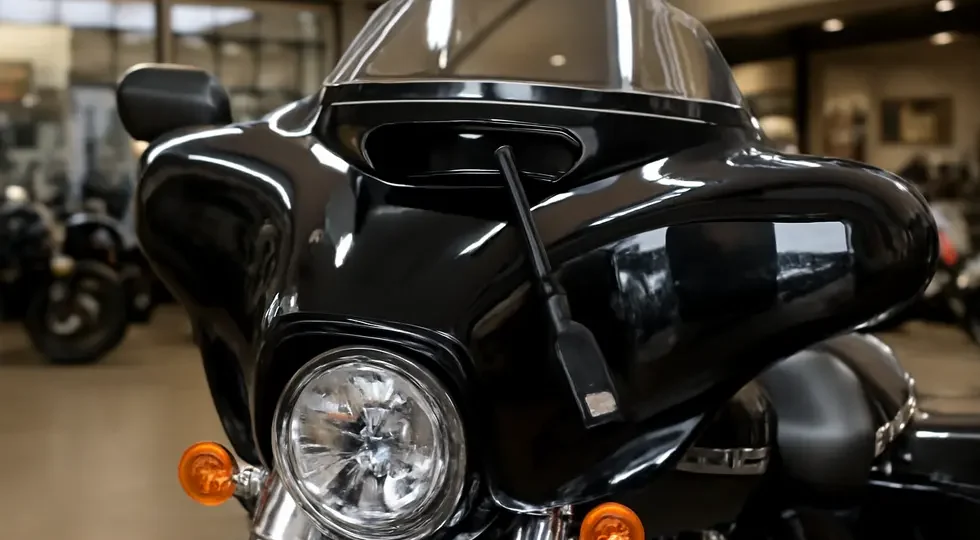 Harley-Davidson touring motorcycle featuring a Batwing fairing with the factory USB cable integrated, showcasing OEM connectivity.