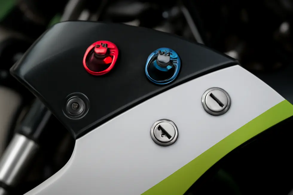 Close-up view of a DZUS fastener illustrating its quarter-turn pin design for quick release and installation on race bike fairings.