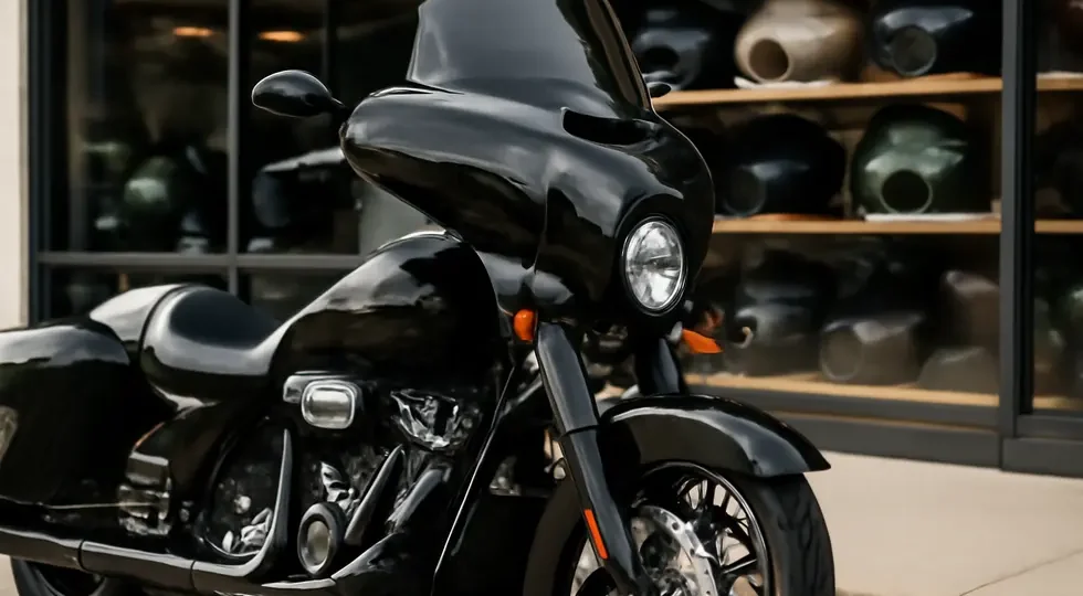 A Harley Davidson motorcycle equipped with a custom fairing kit displayed outdoors in front of a well-stocked motorcycle parts shop.