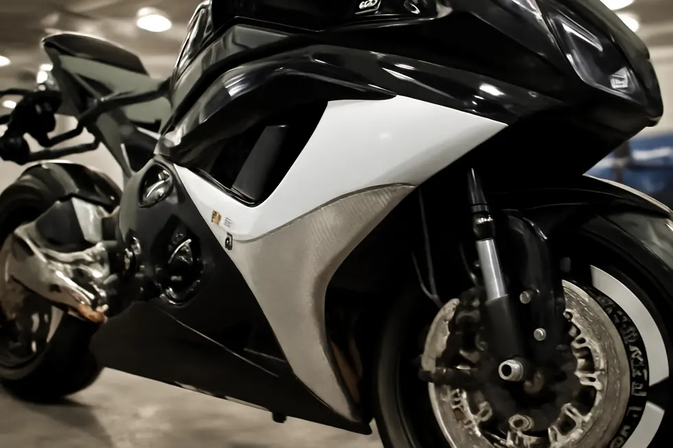 Aftermarket ABS fairing kit featuring integrated heat shields protecting plastic panels around the engine and exhaust.