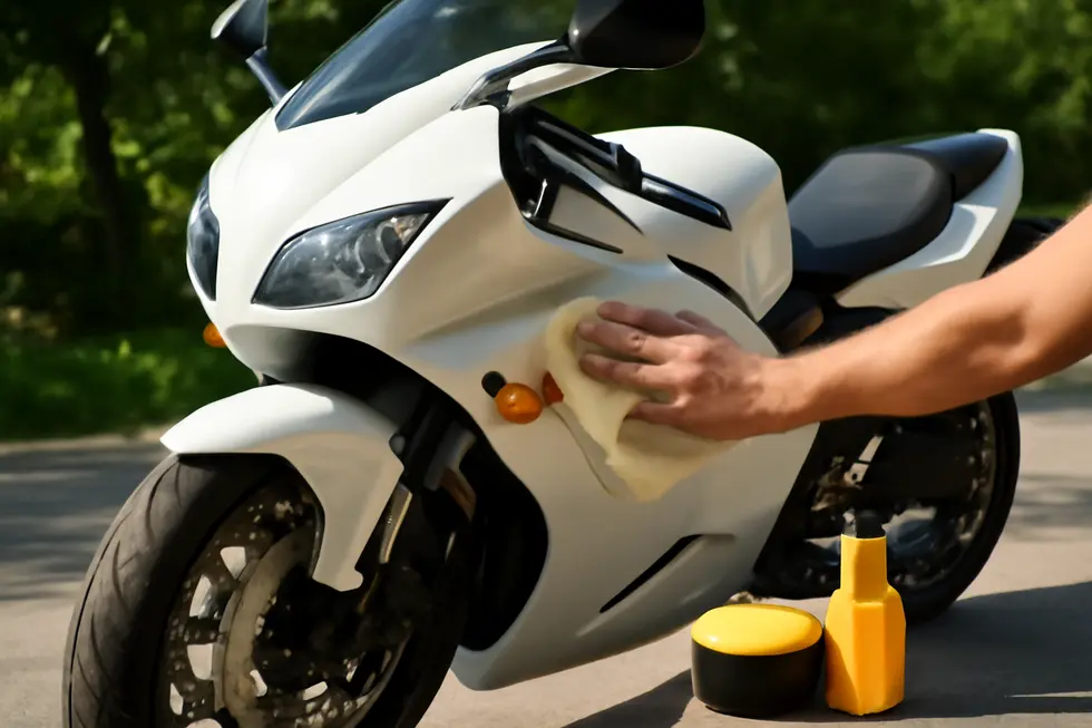 Thorough cleaning and sanding of the motorcycle fairing surface ensure optimal resin adhesion and durability.