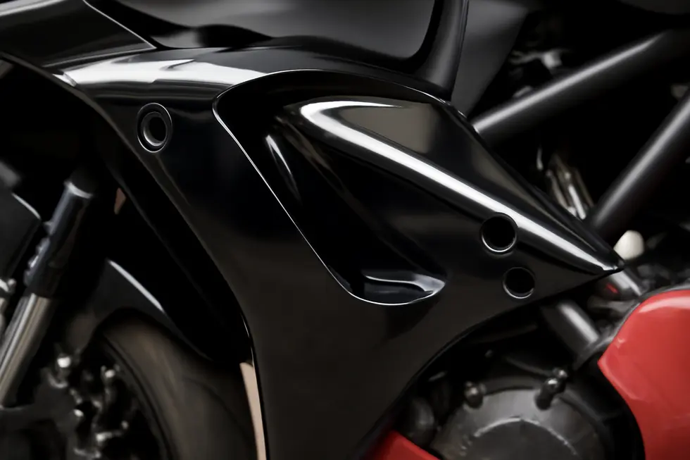 Close-up showing ABS plastic aftermarket fairings with pre-drilled holes for precise fitment on a sportbike frame.