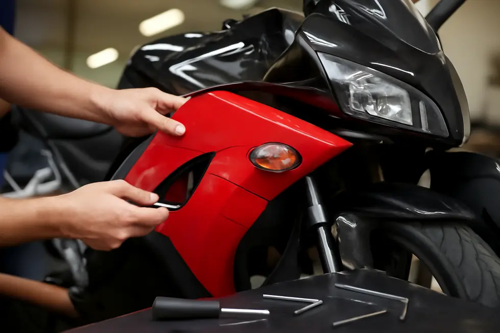 Careful removal and initial damage inspection of motorcycle fairings in a professional garage setting.