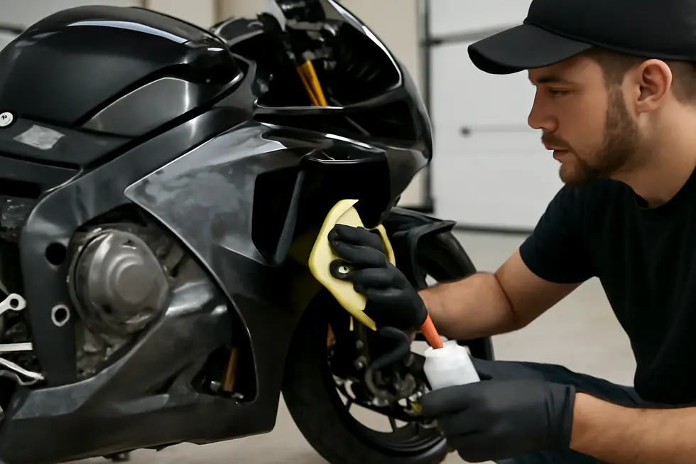 Thoroughly washing motorcycle fairings to remove dirt and contaminants before paint removal.