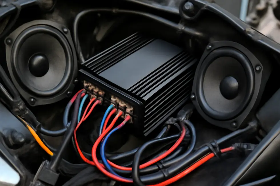 A compact, weather-resistant amplifier flawlessly integrated into a motorcycle fairing, showcasing durability and design.