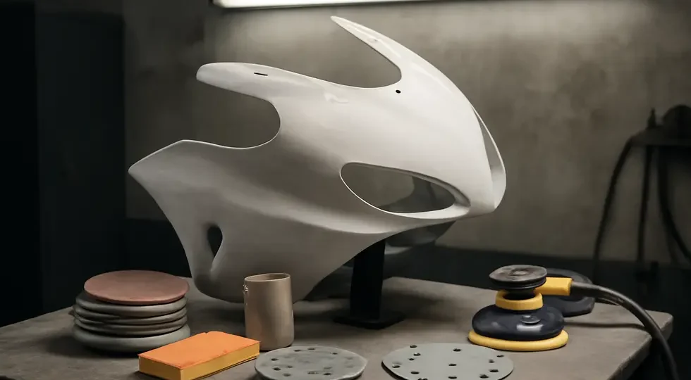 A well-equipped workspace showcasing expert sanding preparation on a motorcycle fairing.