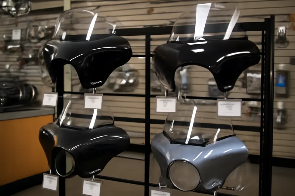 Close-up display of ABS plastic, fiberglass, and carbon fiber materials used in cruiser motorcycle fairings.