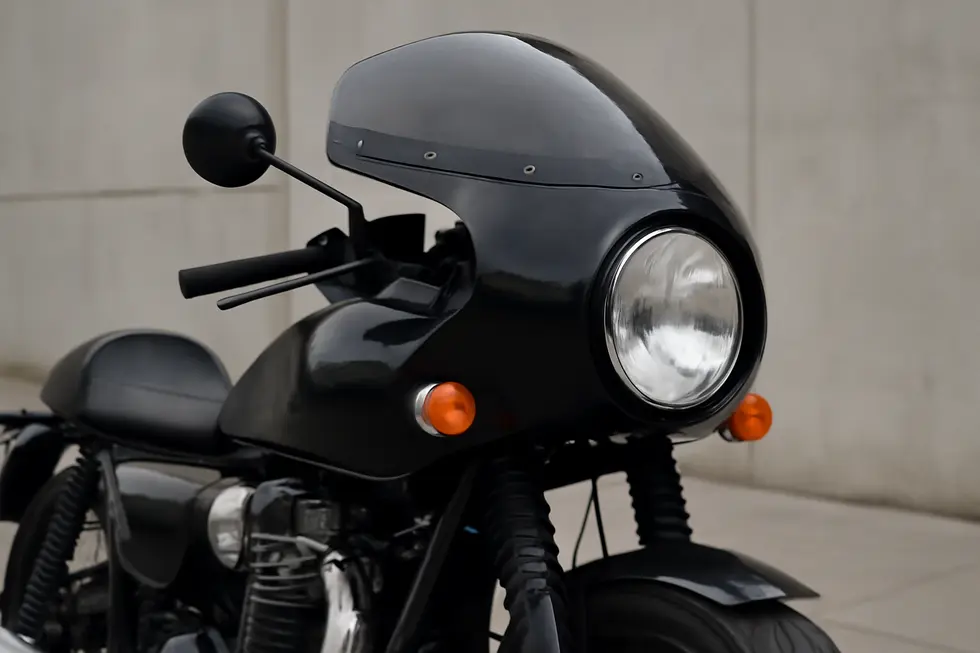 Close-up of a retro motorcycle fairing highlighting the vintage-inspired design and iconic round headlight style.