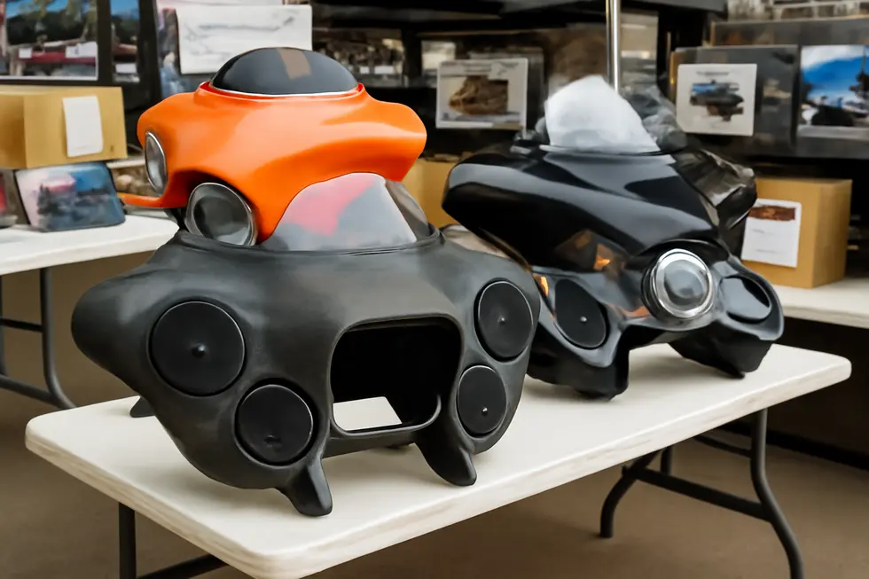 Detailed view of a modern motorcycle fairing stereo system highlighting its protective design and premium speaker components.