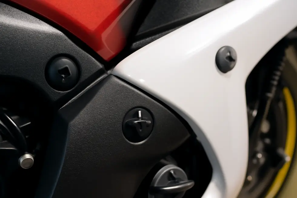 A detailed look at how motorcycle fairing push pins secure panels while allowing easy maintenance access.