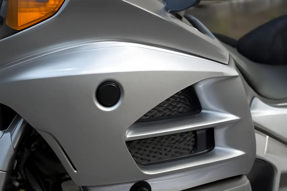 A detailed look at how motorcycle fairing push pins secure panels while allowing easy maintenance access.