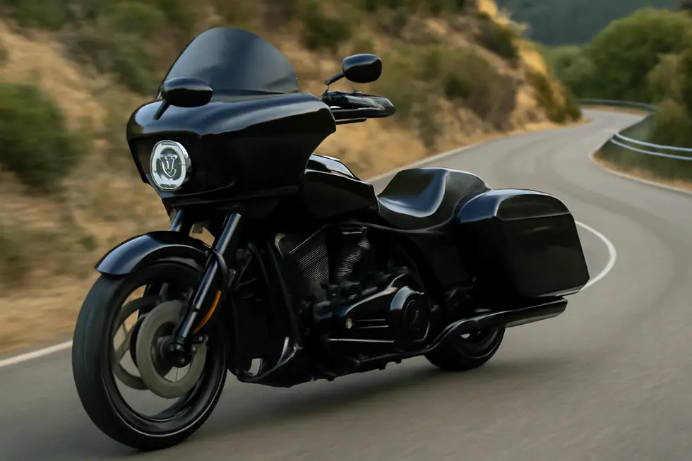 A modern touring motorcycle equipped with an aerodynamic windshield maximizing wind protection for enhanced rider comfort.