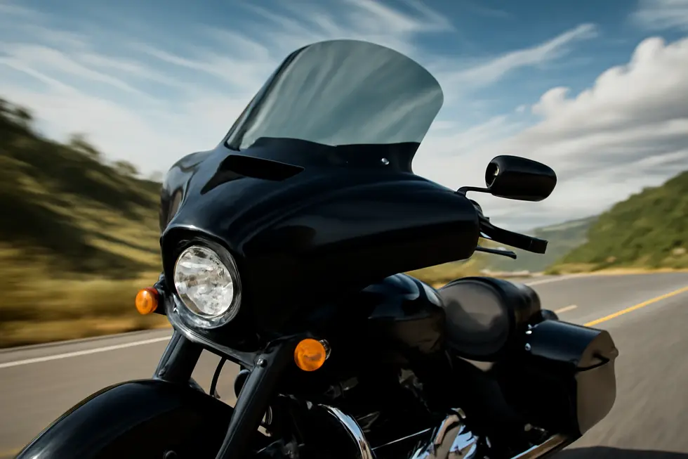 A modern touring motorcycle equipped with an aerodynamic windshield maximizing wind protection for enhanced rider comfort.