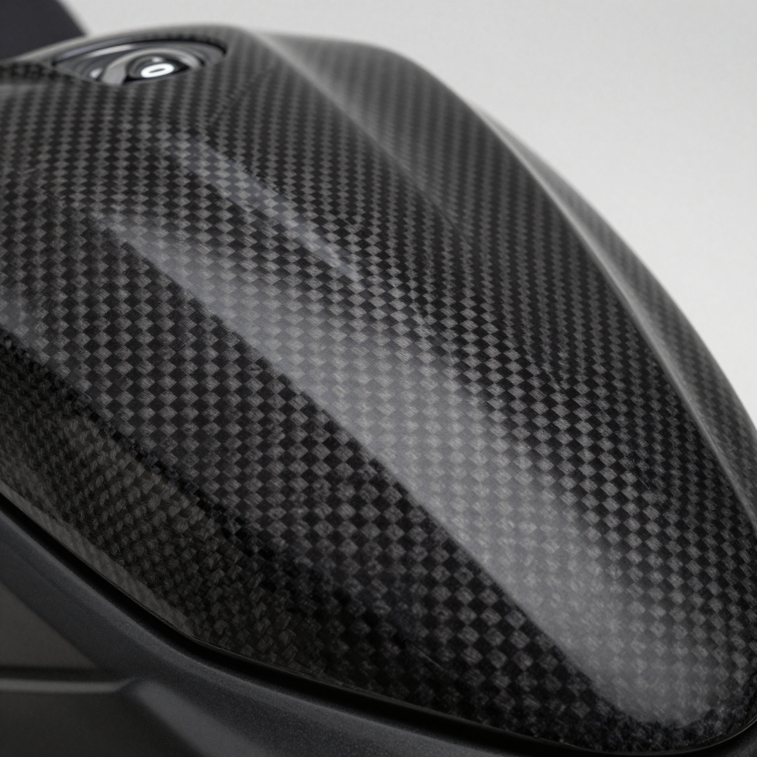 Premium carbon fiber fairing surface with gloss finish and studio lighting
